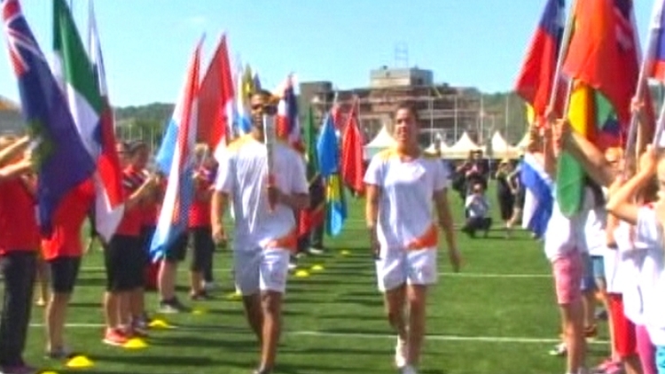 Darnell Nurse (left) and Kia Nurse run the Pan Am torch into the CIBC Pan Am Soccer stadium; Hamilton, June 22, 2015